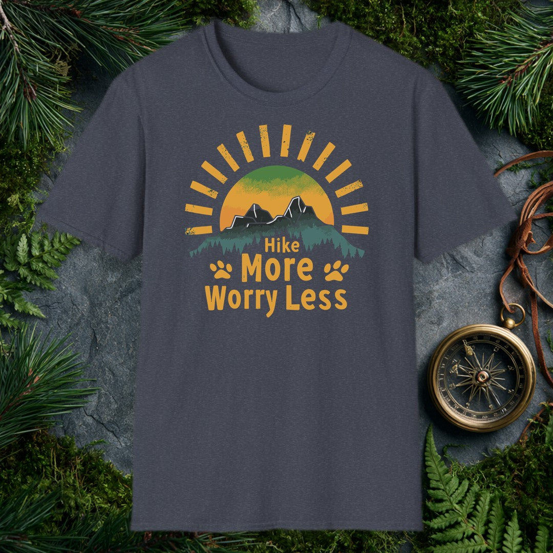 A half-sun rises behind two jagged mountain peaks and a ridge of dark pines, with paw prints flanking the words Hike More Worry Less — for the hiker who brings…