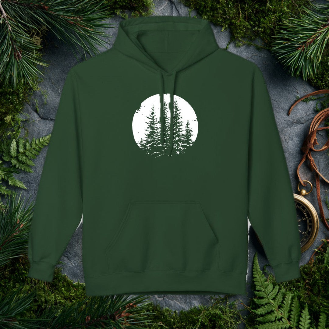 Three snow-laden spruce trees rise against a deep black sky, framed in a worn circular vignette — made for the person who knows what a cold, quiet forest…