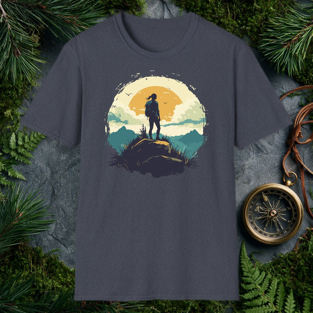 silhouette of a female hiker on a boulder against a large amber sun, teal mountain ridges, and two birds in a vintage ci