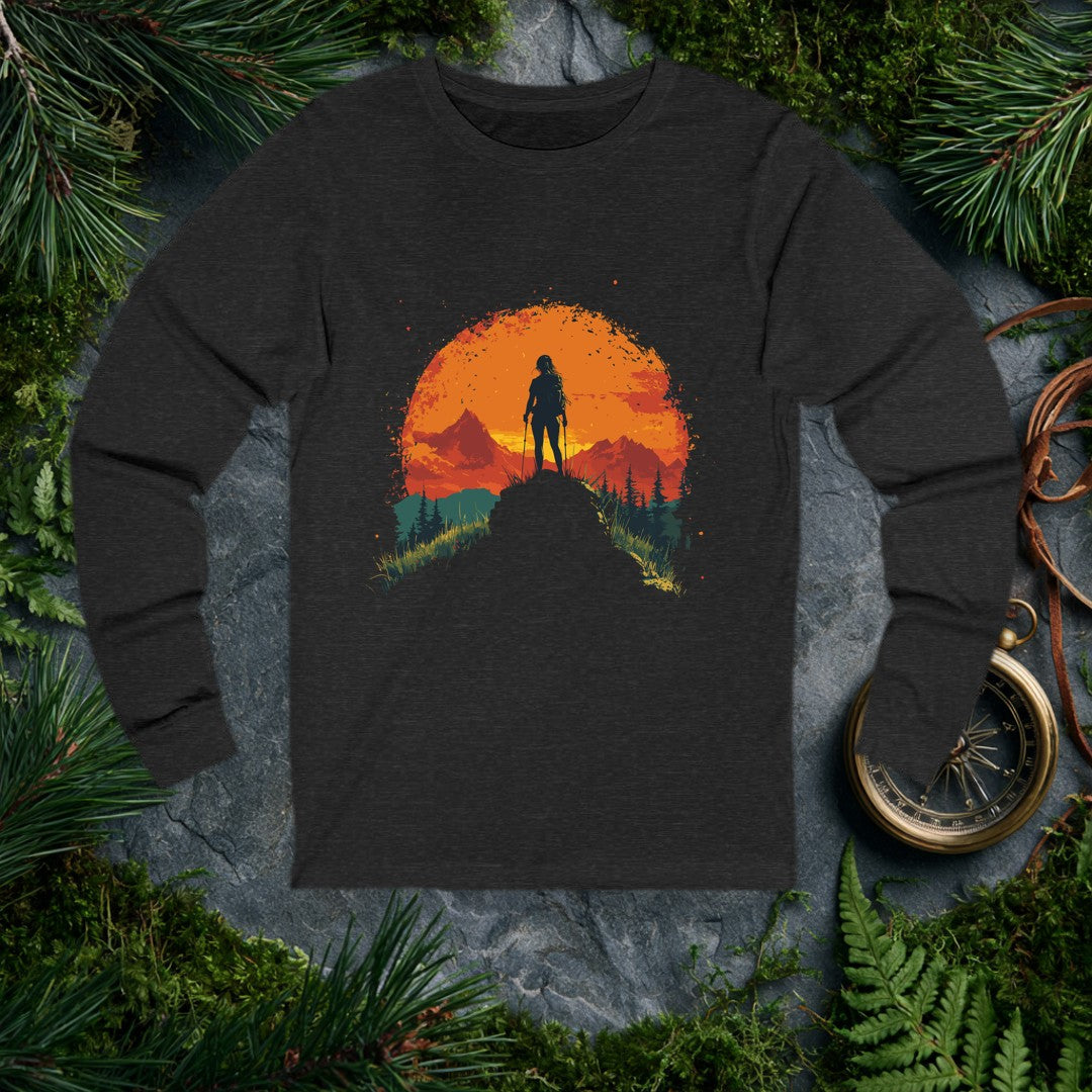 A female hiker stands with trekking poles against a sprawling orange sun, mountains rolling behind her and pine silhouettes framing the foreground — drawn for…