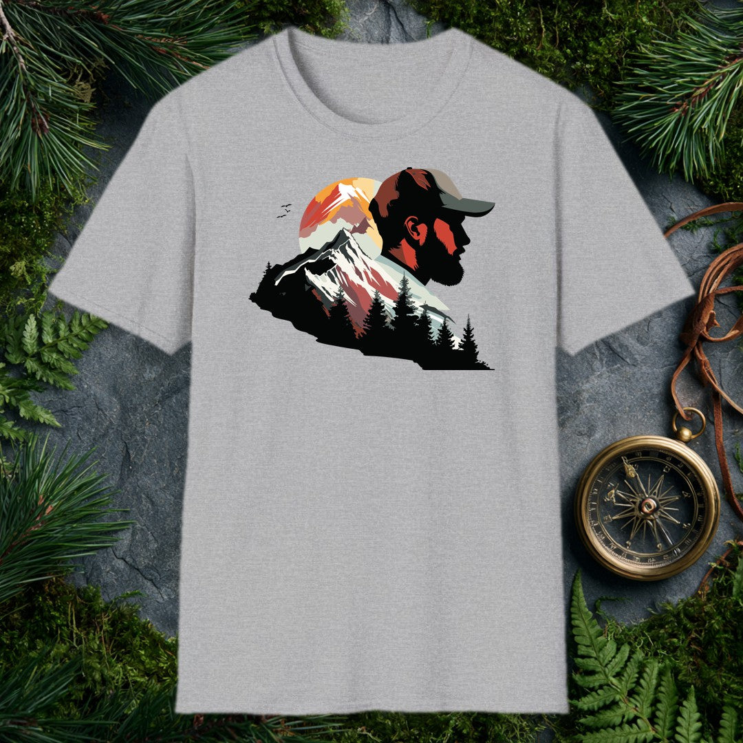A bearded man in a trail cap gazes into a double-exposure scene — snow-capped peaks rising through a warm sunset circle, pine silhouettes crowding the valley…