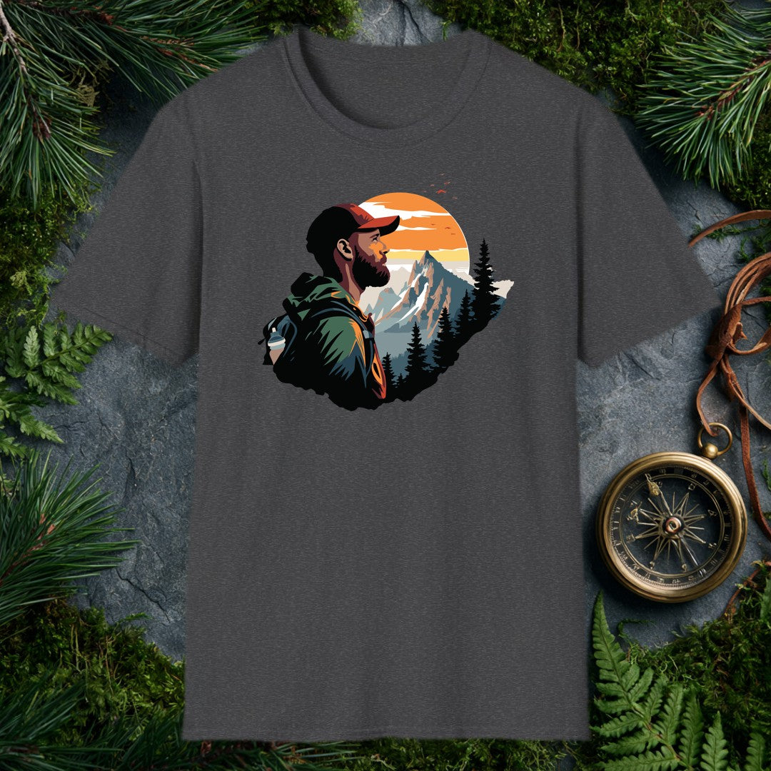 A bearded hiker with a loaded pack pauses to take in a snow-capped peak rising above a pine forest under a wide orange sunrise — for the person who knows…