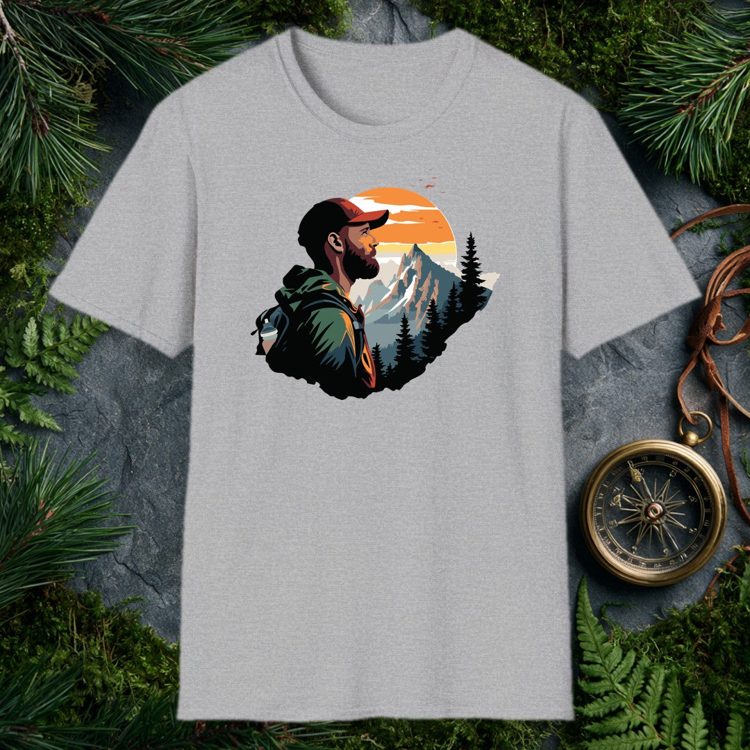 A bearded hiker with a loaded pack pauses to take in a snow-capped peak rising above a pine forest under a wide orange sunrise — for the person who knows…