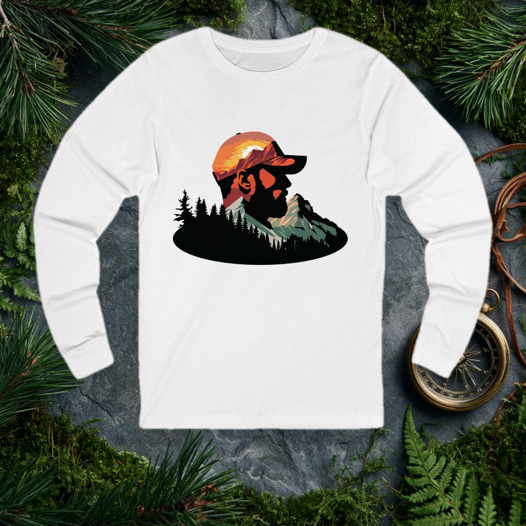 A bearded man in a ball cap becomes the landscape itself — mountains rise through his profile, pines crowd the ridge below, and a warm sunset burns behind the…