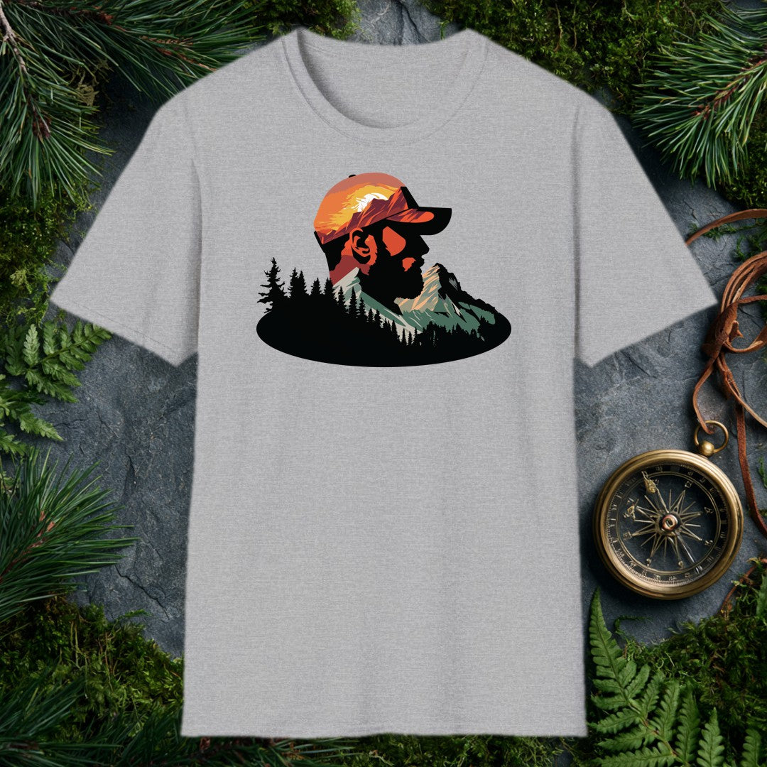 A bearded man in a ball cap becomes the landscape itself — mountains rise through his profile, pines crowd the ridge below, and a warm sunset burns behind the…