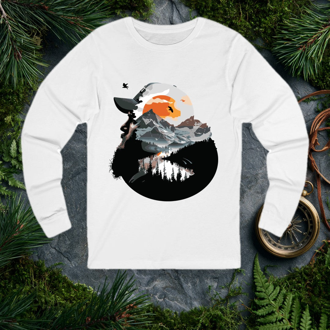 A bearded hiker looks skyward into a double-exposure scene — snow-capped peaks, a mirror-still alpine lake, pine silhouettes, and a rising amber sun with birds…