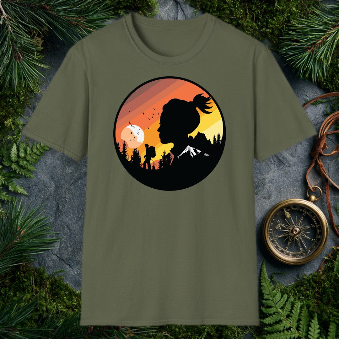 A woman's silhouette faces the horizon while a lone backpacker picks a trail through pine shadows beneath a striped sunset sky — birds lifting off a wide…