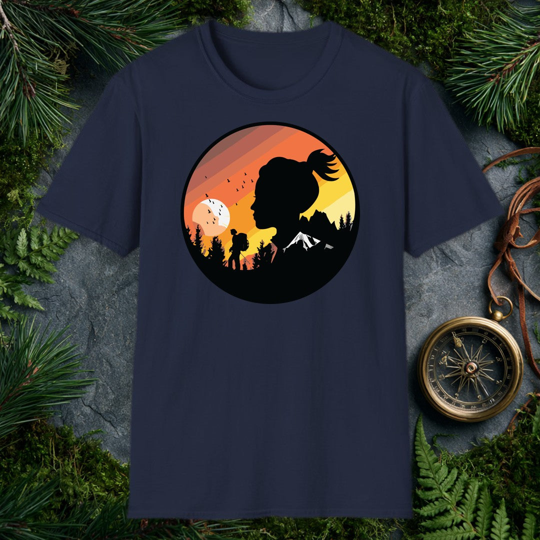 A woman's silhouette faces the horizon while a lone backpacker picks a trail through pine shadows beneath a striped sunset sky — birds lifting off a wide…