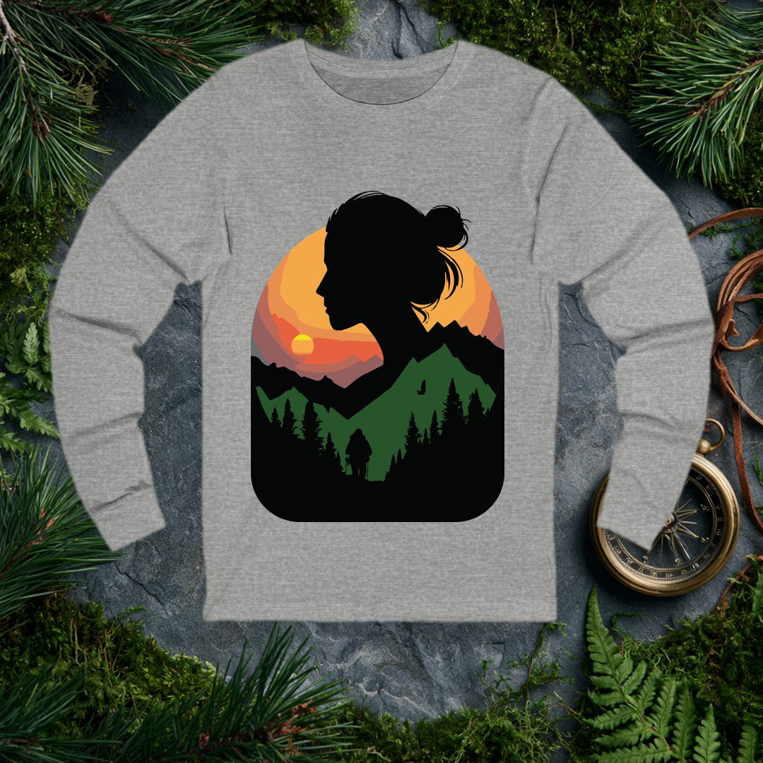 A woman's silhouette frames a layered mountain sunset — pine forest below, a lone backpacker on the trail, a bird crossing the orange sky above the ridgeline.…