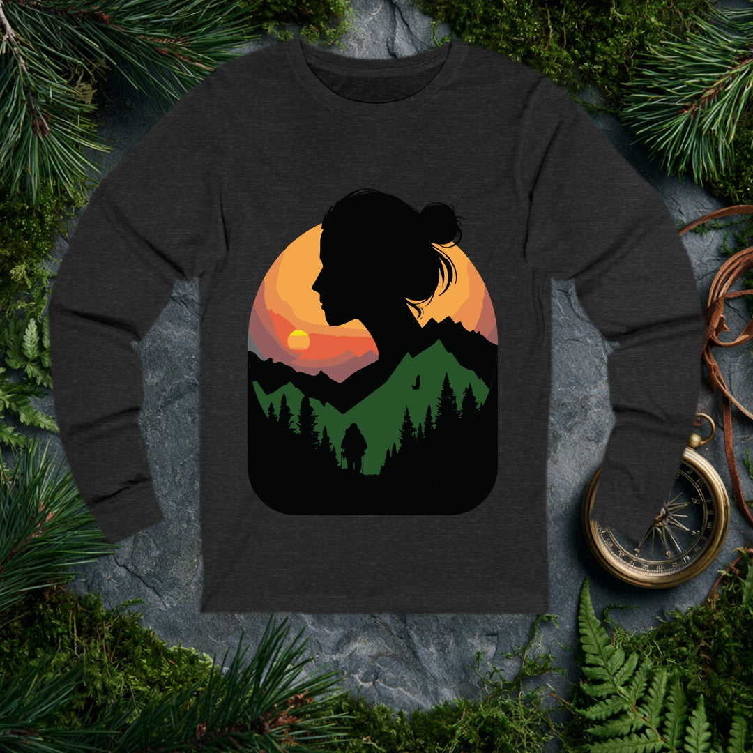 A woman's silhouette frames a layered mountain sunset — pine forest below, a lone backpacker on the trail, a bird crossing the orange sky above the ridgeline.…