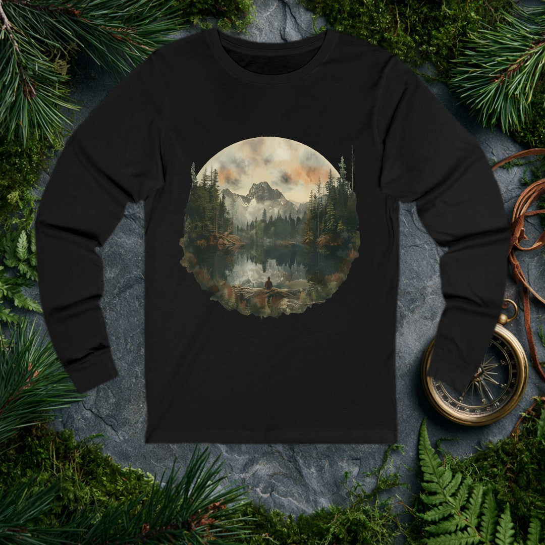 A lone figure sits on a fallen log at the edge of a still alpine lake, watching jagged snow-capped peaks and a stand of dark pines mirror themselves perfectly…