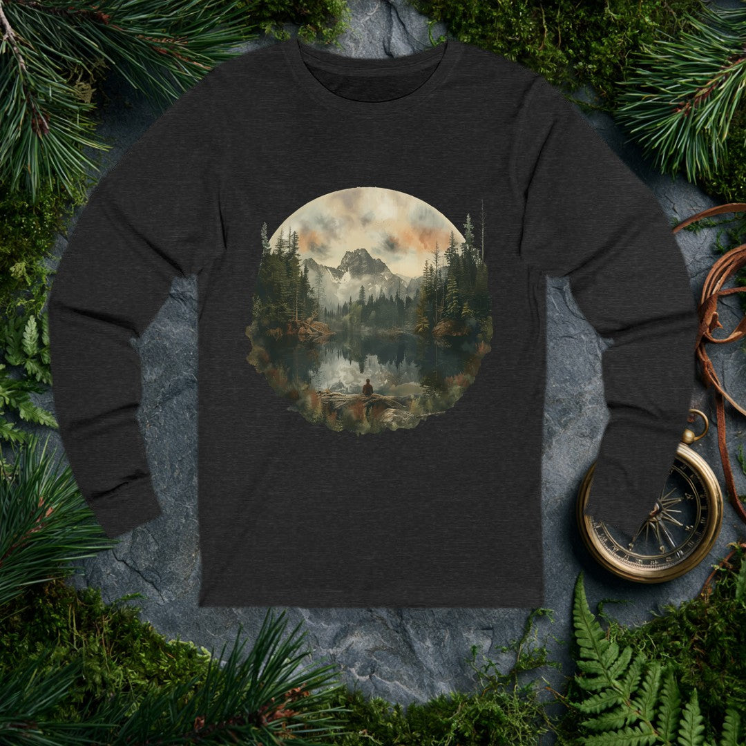 A lone figure sits on a fallen log at the edge of a still alpine lake, watching jagged snow-capped peaks and a stand of dark pines mirror themselves perfectly…