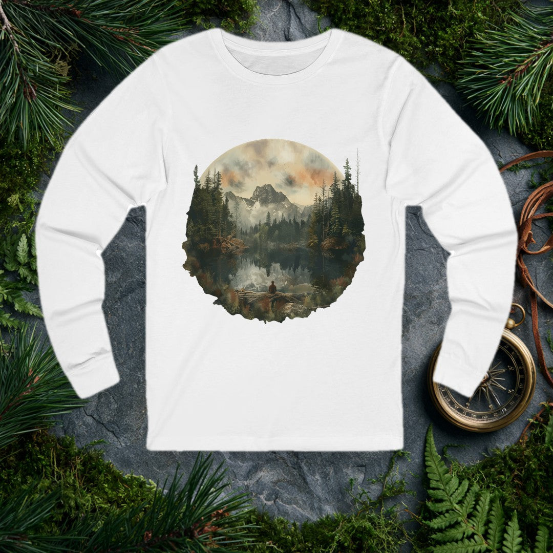 A lone figure sits on a fallen log at the edge of a still alpine lake, watching jagged snow-capped peaks and a stand of dark pines mirror themselves perfectly…