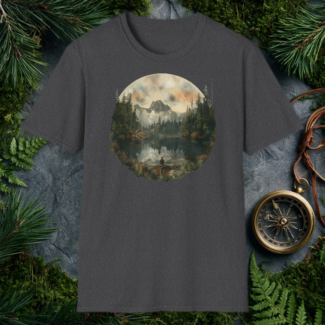 A lone figure sits on a fallen log at the edge of a still alpine lake, watching jagged snow-capped peaks and a stand of dark pines mirror themselves perfectly…