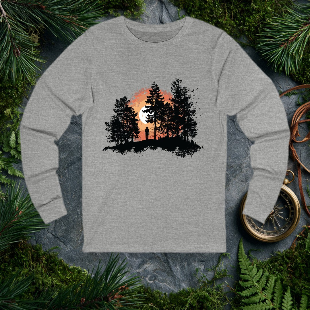 A solitary figure stands among tall pines as a wide sun sets behind them, birds lifting off to the right — for the one who crests a ridge and just stops to…