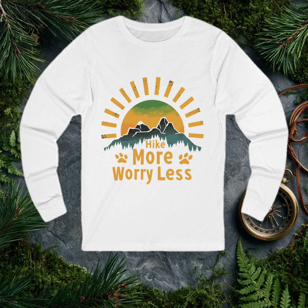 A half-sun rises behind two jagged mountain peaks and a ridge of dark pines, with paw prints flanking the words Hike More Worry Less — for the hiker who brings…