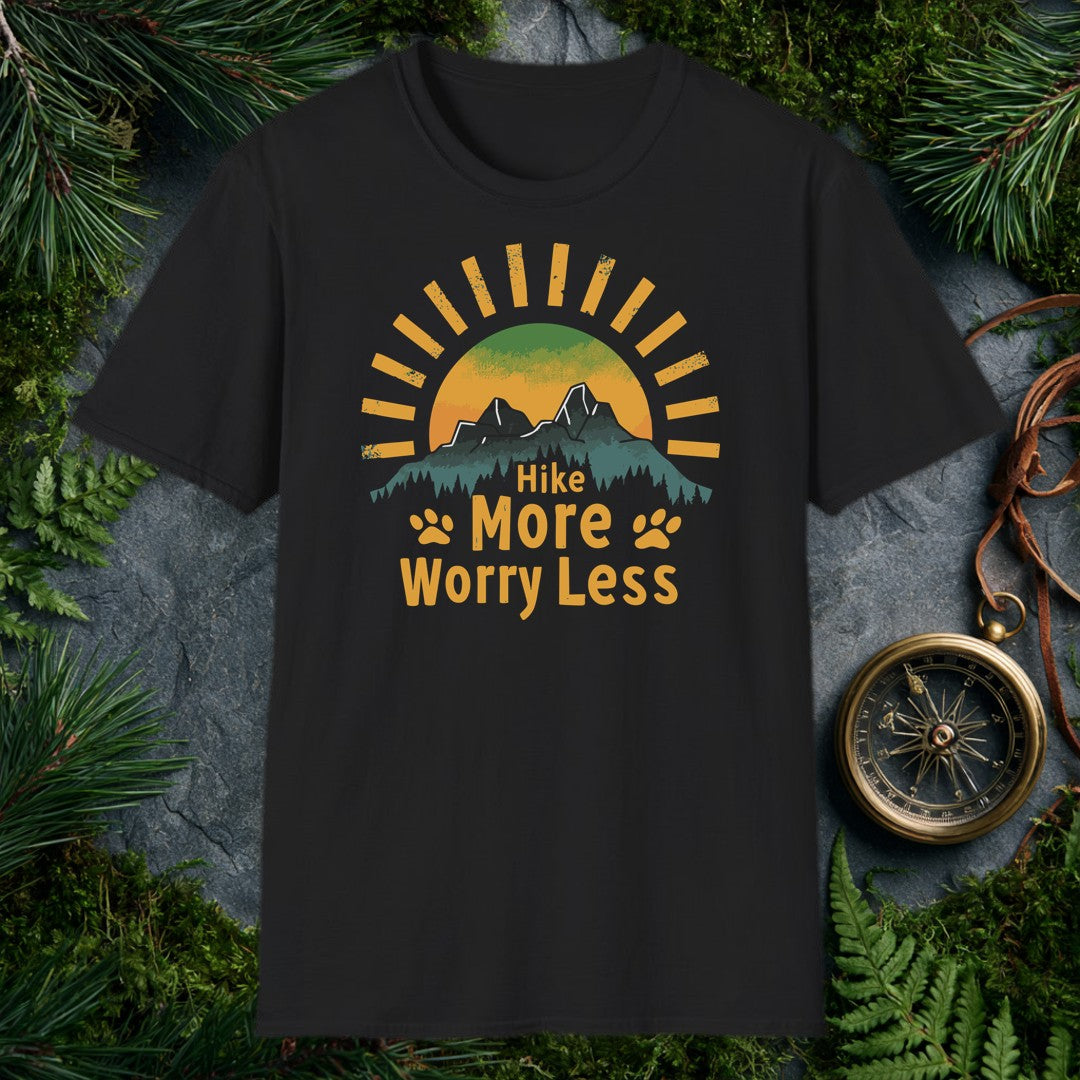 A half-sun rises behind two jagged mountain peaks and a ridge of dark pines, with paw prints flanking the words Hike More Worry Less — for the hiker who brings…