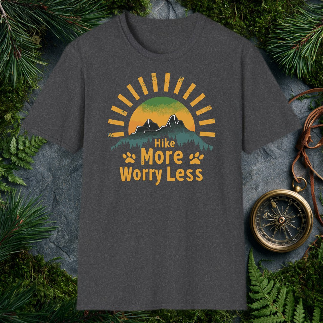 A half-sun rises behind two jagged mountain peaks and a ridge of dark pines, with paw prints flanking the words Hike More Worry Less — for the hiker who brings…