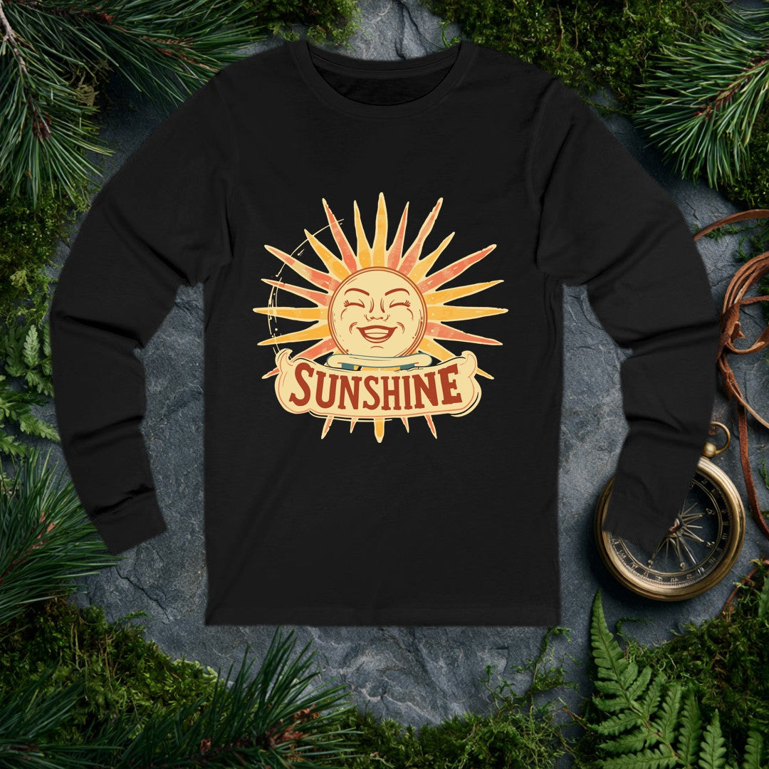 A grinning retro sun — rosy cheeks, laughing eyes, rays blazing in amber and coral — beams above a hand-lettered banner that reads Sunshine . For the optimist…