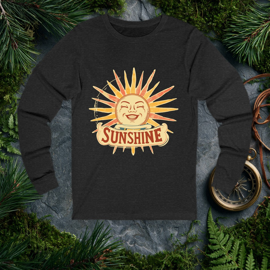 A grinning retro sun — rosy cheeks, laughing eyes, rays blazing in amber and coral — beams above a hand-lettered banner that reads Sunshine . For the optimist…