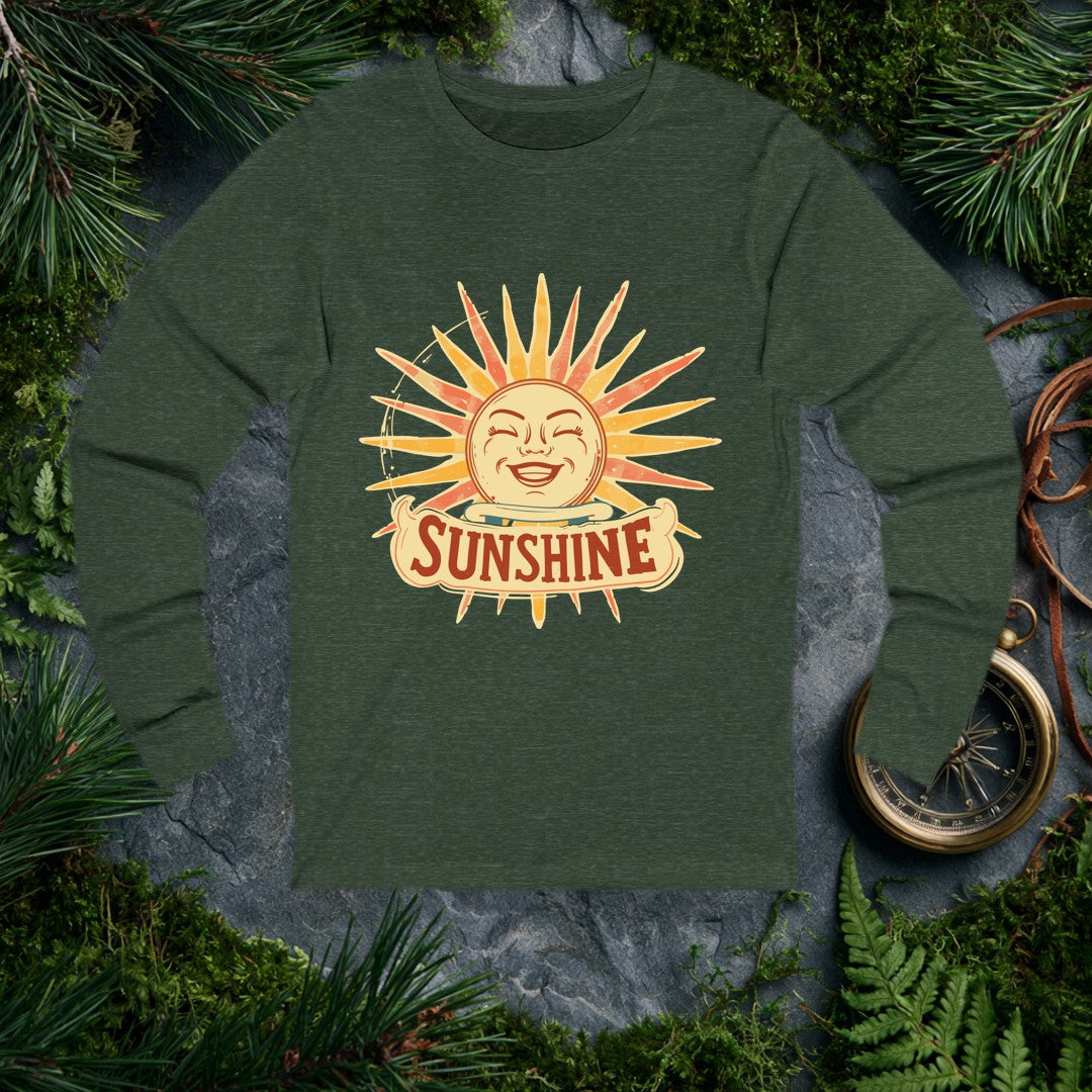A grinning retro sun — rosy cheeks, laughing eyes, rays blazing in amber and coral — beams above a hand-lettered banner that reads Sunshine . For the optimist…