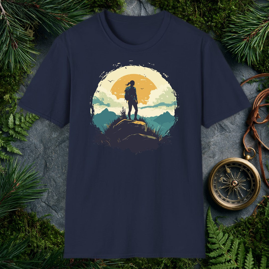 silhouette of a female hiker on a boulder against a large amber sun, teal mountain ridges, and two birds in a vintage ci