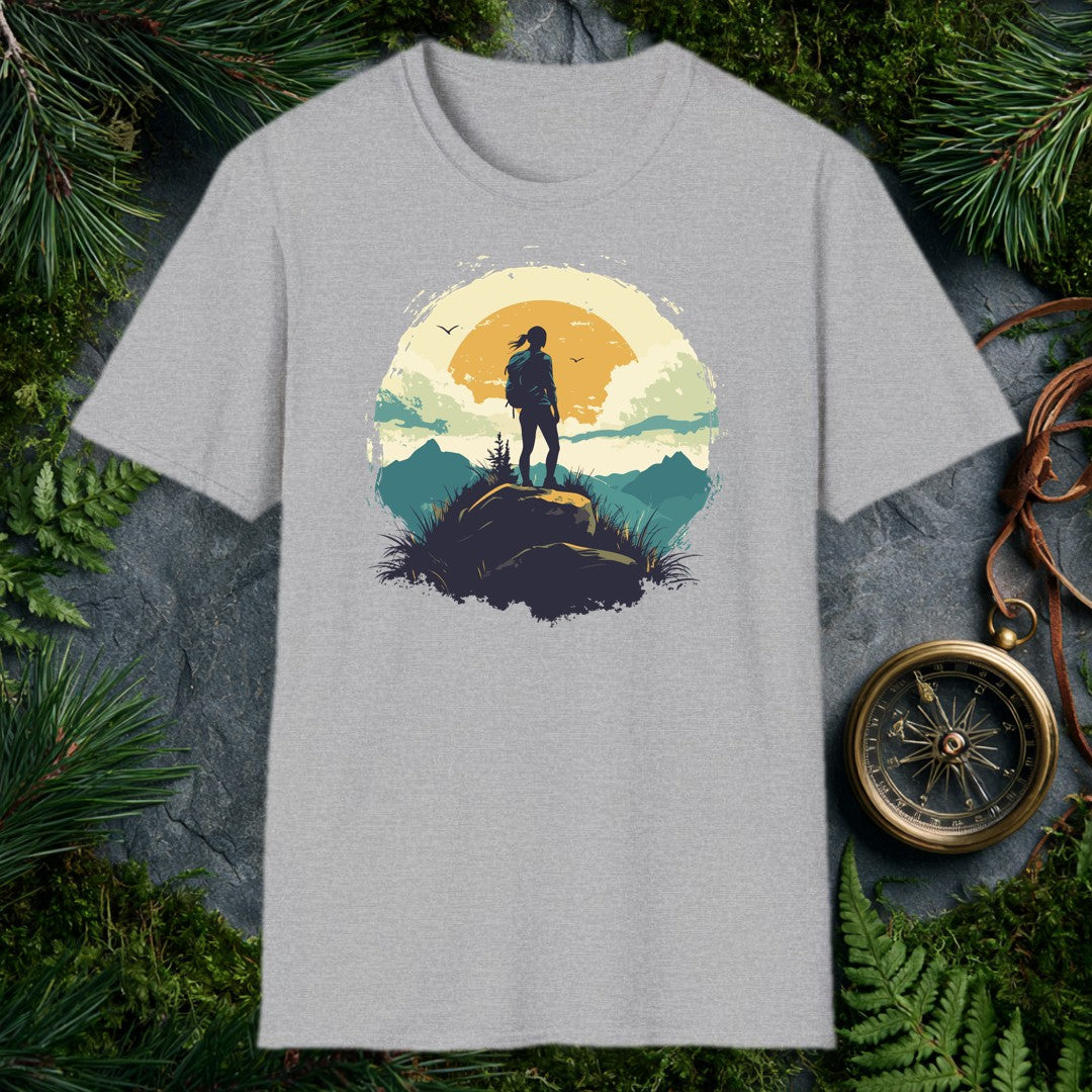 silhouette of a female hiker on a boulder against a large amber sun, teal mountain ridges, and two birds in a vintage ci