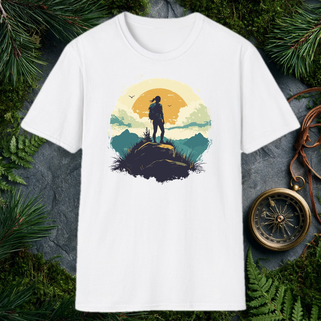 silhouette of a female hiker on a boulder against a large amber sun, teal mountain ridges, and two birds in a vintage ci
