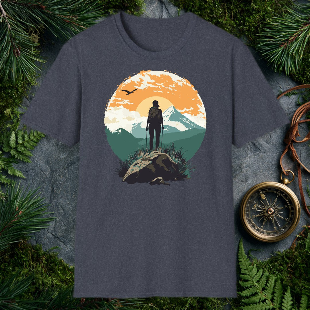 silhouette of female hiker with trekking poles on rocky summit, snow-capped mountain and orange sunrise behind her, bird