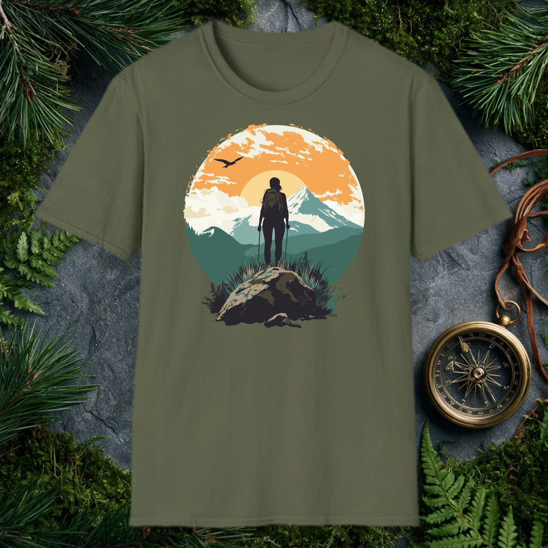 silhouette of female hiker with trekking poles on rocky summit, snow-capped mountain and orange sunrise behind her, bird