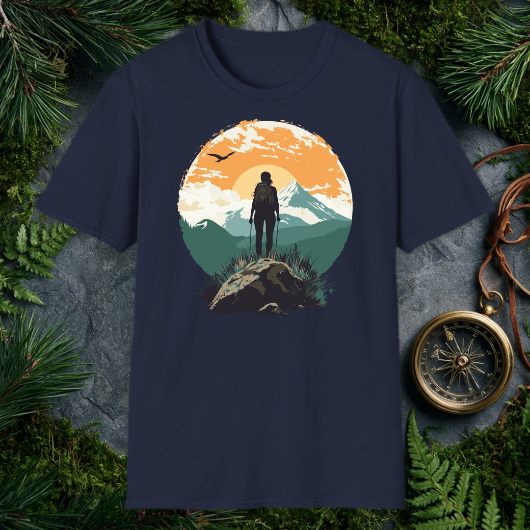 silhouette of female hiker with trekking poles on rocky summit, snow-capped mountain and orange sunrise behind her, bird