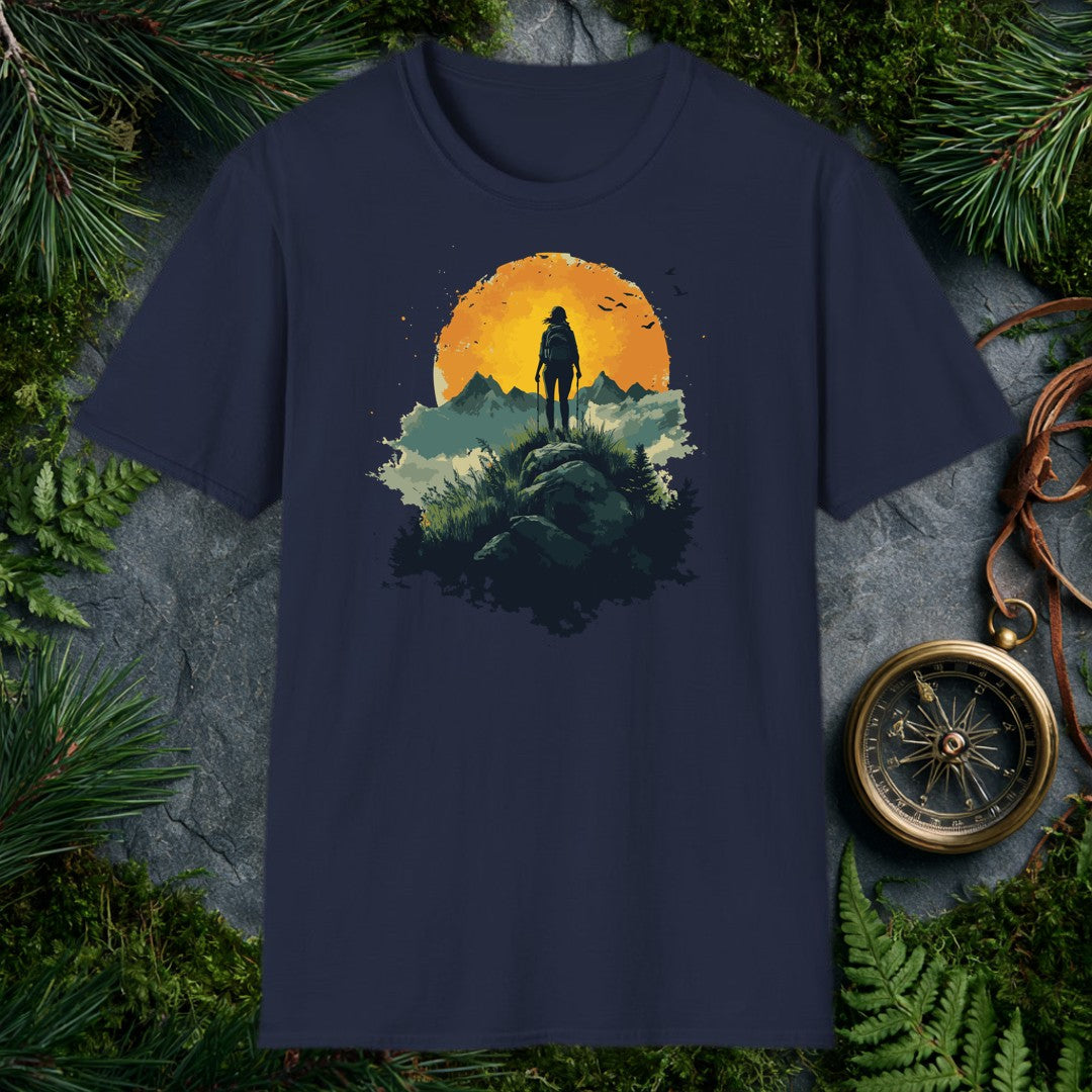 woman hiker silhouette with trekking poles atop a rocky ridge, large amber sun and mountain peaks behind her, birds in f