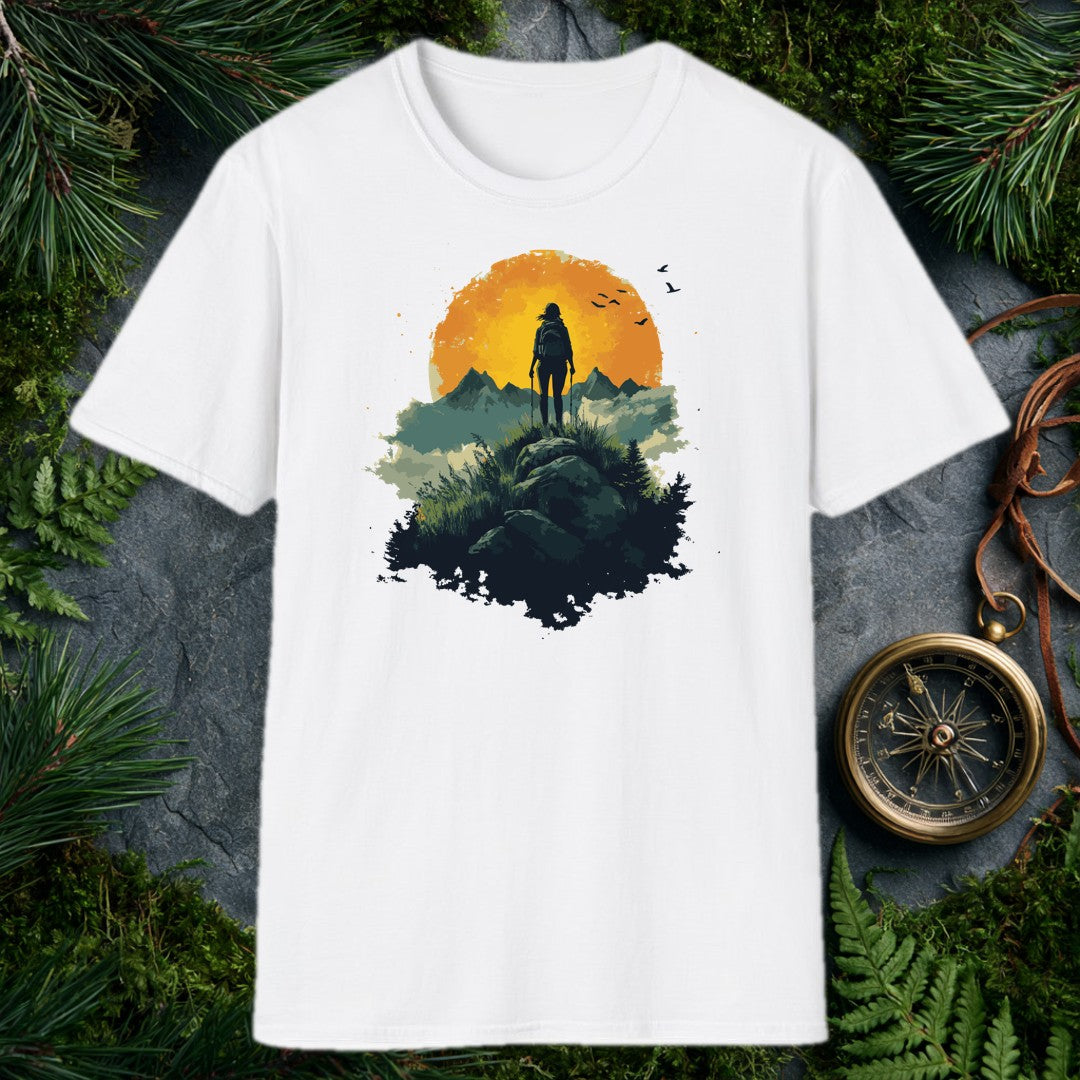 woman hiker silhouette with trekking poles atop a rocky ridge, large amber sun and mountain peaks behind her, birds in f